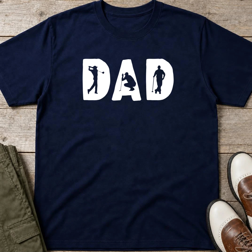 Golf Dad T-Shirt in Navy lying on a plain floor. T-shirt is a unisex cut and 100 per cent cotton.