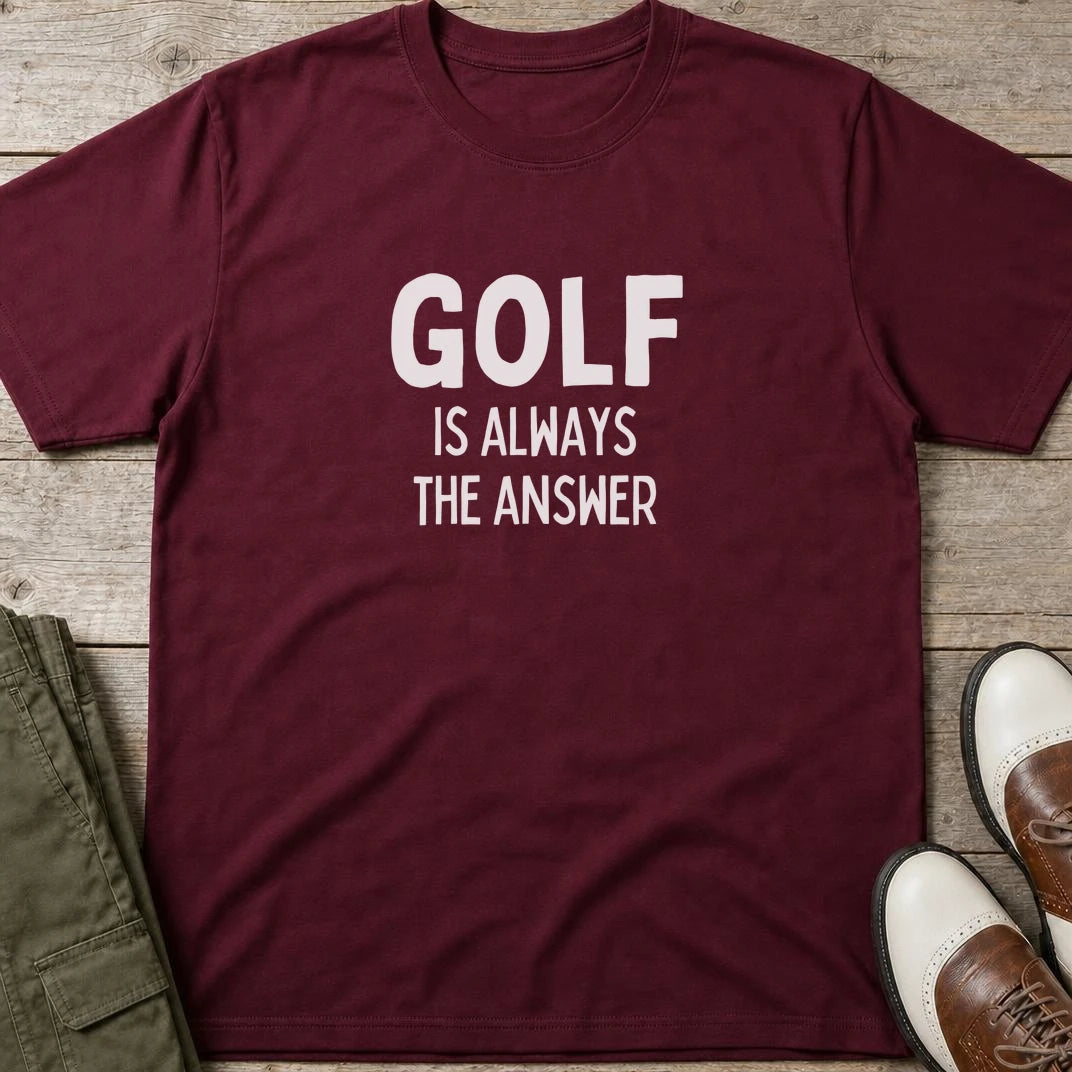 Golf The Answer T-Shirt in Maroon lying on a plain floor. T-shirt is a unisex cut and 100 per cent cotton.