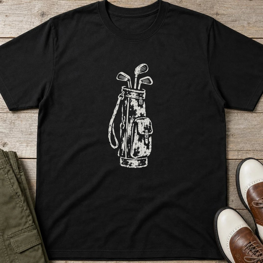 Vintage Golf Bag T-Shirt in Black lying on a plain floor. T-shirt is a unisex cut and 100 per cent cotton.