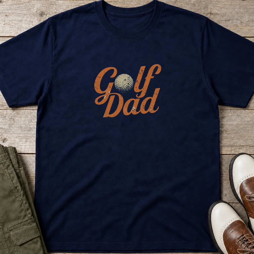 Golf Dad II T-Shirt in Navy lying on a plain floor. T-shirt is a unisex cut and 100 per cent cotton.