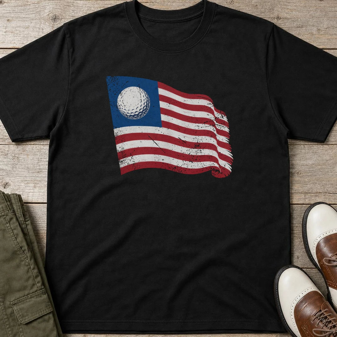 Golf Flag T-Shirt in Black lying on a plain floor. T-shirt is a unisex cut and 100 per cent cotton.