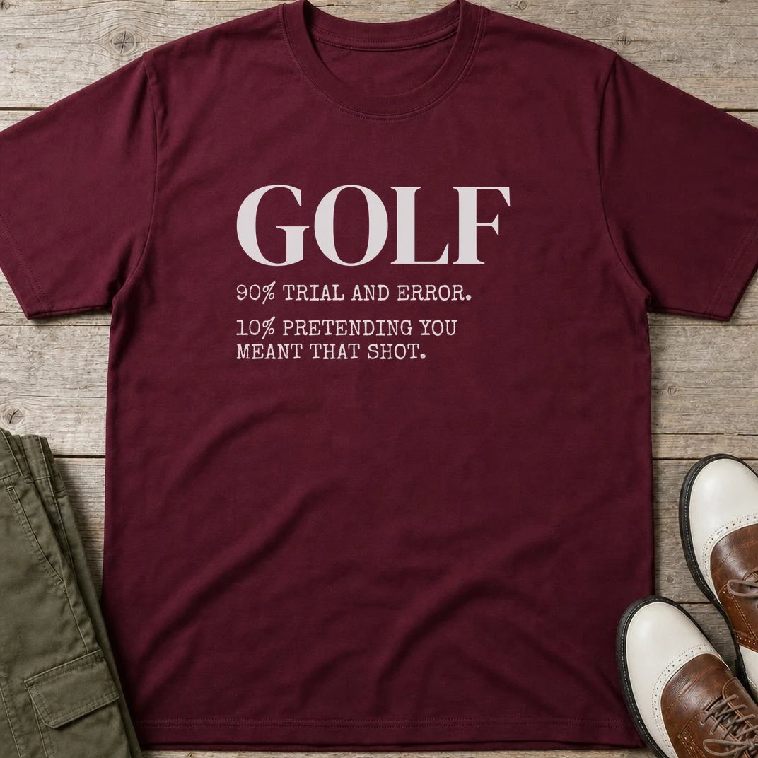 Pretending T-Shirt in Maroon lying on a plain floor. T-shirt is a unisex cut and 100 per cent cotton.
