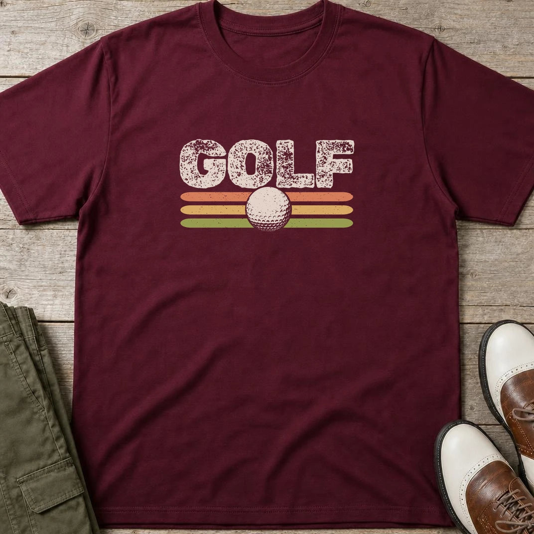 Golf Retro T-Shirt in Maroon lying on a plain floor. T-shirt is a unisex cut and 100 per cent cotton.