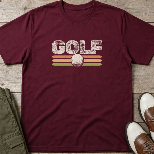 Golf Retro T-Shirt in Maroon lying on a plain floor. T-shirt is a unisex cut and 100 per cent cotton.