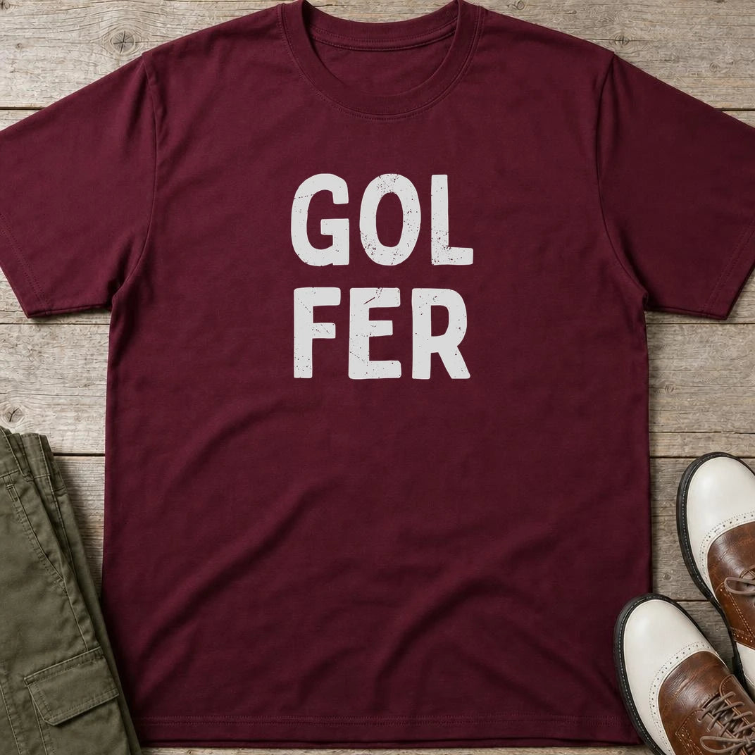 Gol Fer T-Shirt in Maroon lying on a plain floor. T-shirt is a unisex cut and 100 per cent cotton.