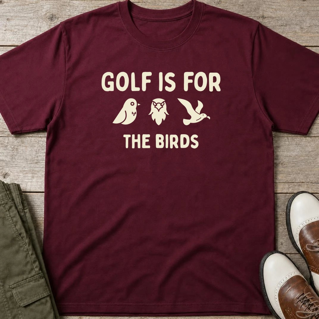 The Birds T-Shirt in Maroon lying on a plain floor. T-shirt is a unisex cut and 100 per cent cotton.