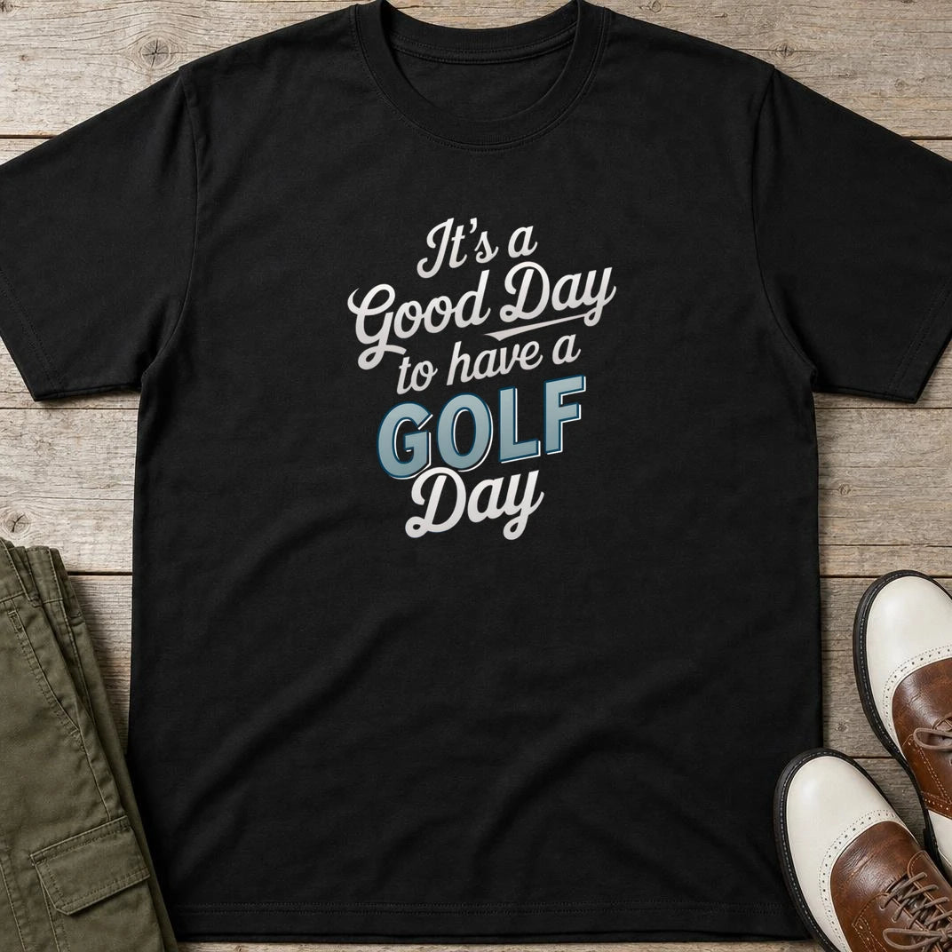 Golf Day T-Shirt in lying on a plain floor. T-shirt is a unisex cut and 100 per cent cotton.
