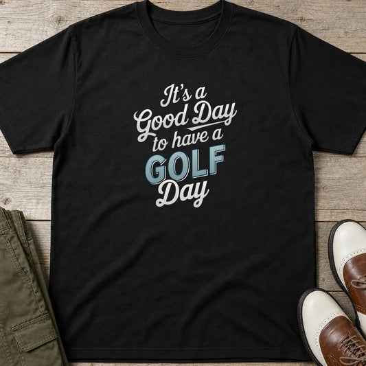 Golf Day T-Shirt in lying on a plain floor. T-shirt is a unisex cut and 100 per cent cotton.