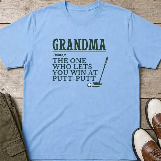 Grandma Putt-Putt T-Shirt in Light Blue lying on a plain floor. T-shirt is a unisex cut and 100 per cent cotton.