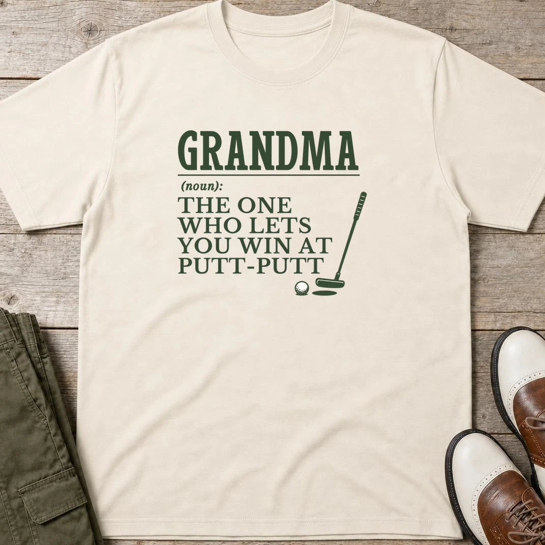 Grandma Putt-Putt T-Shirt in Natural lying on a plain floor. T-shirt is a unisex cut and 100 per cent cotton.