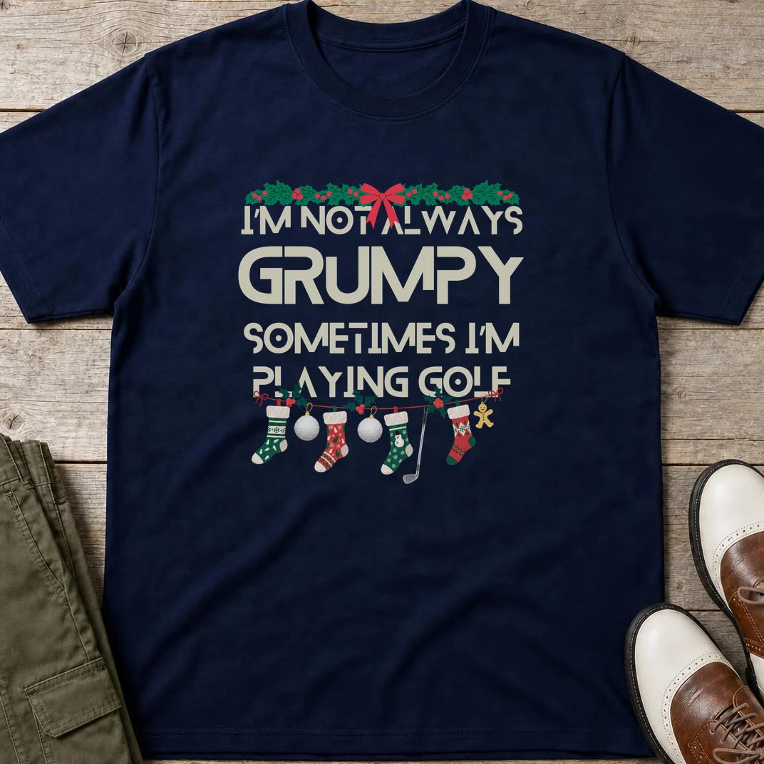 Grumpy Christmas T-Shirt in Navy lying on a plain floor. T-shirt is a unisex cut and 100 per cent cotton.
