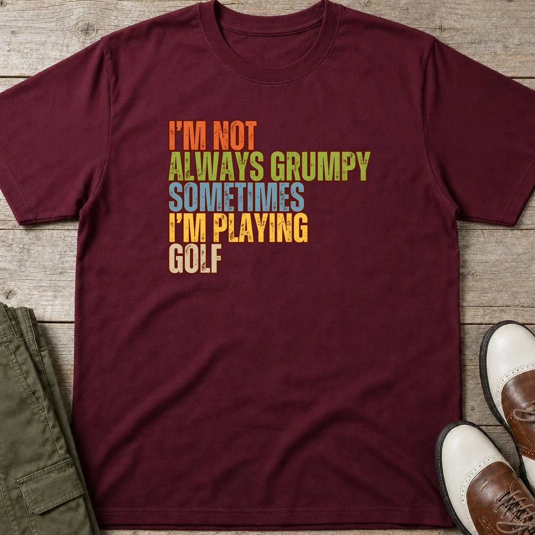 Grumpy Classic T-Shirt in Maroon lying on a plain floor. T-shirt is a unisex cut and 100 per cent cotton.