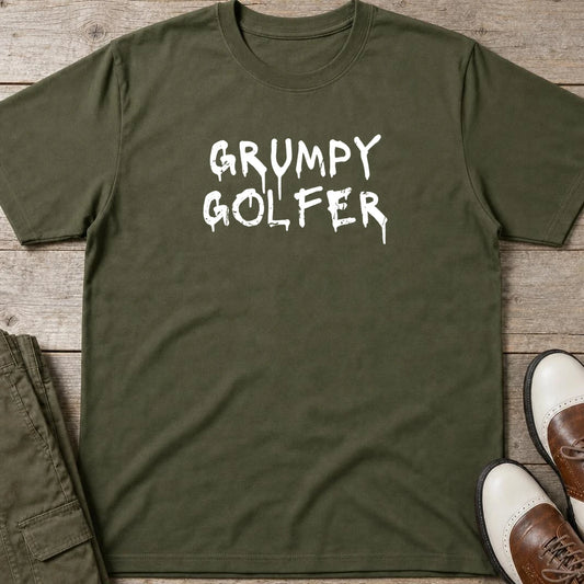 Grumpy Golfer T-Shirt in Military Green lying on a plain floor. T-shirt is a unisex cut and 100 per cent cotton.