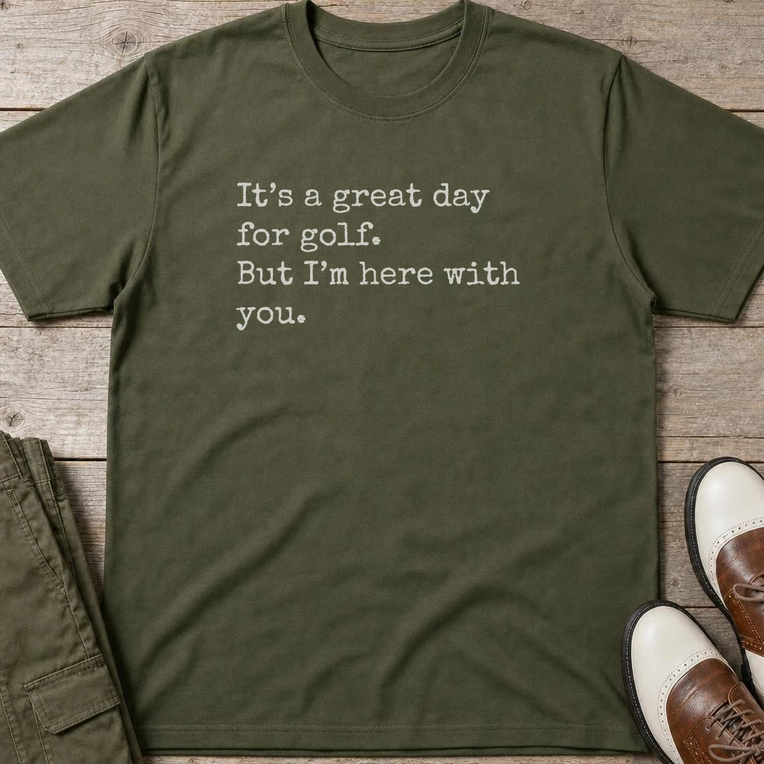 Here With You T-Shirt in Military Green lying on a plain floor. T-shirt is a unisex cut and 100 per cent cotton.
