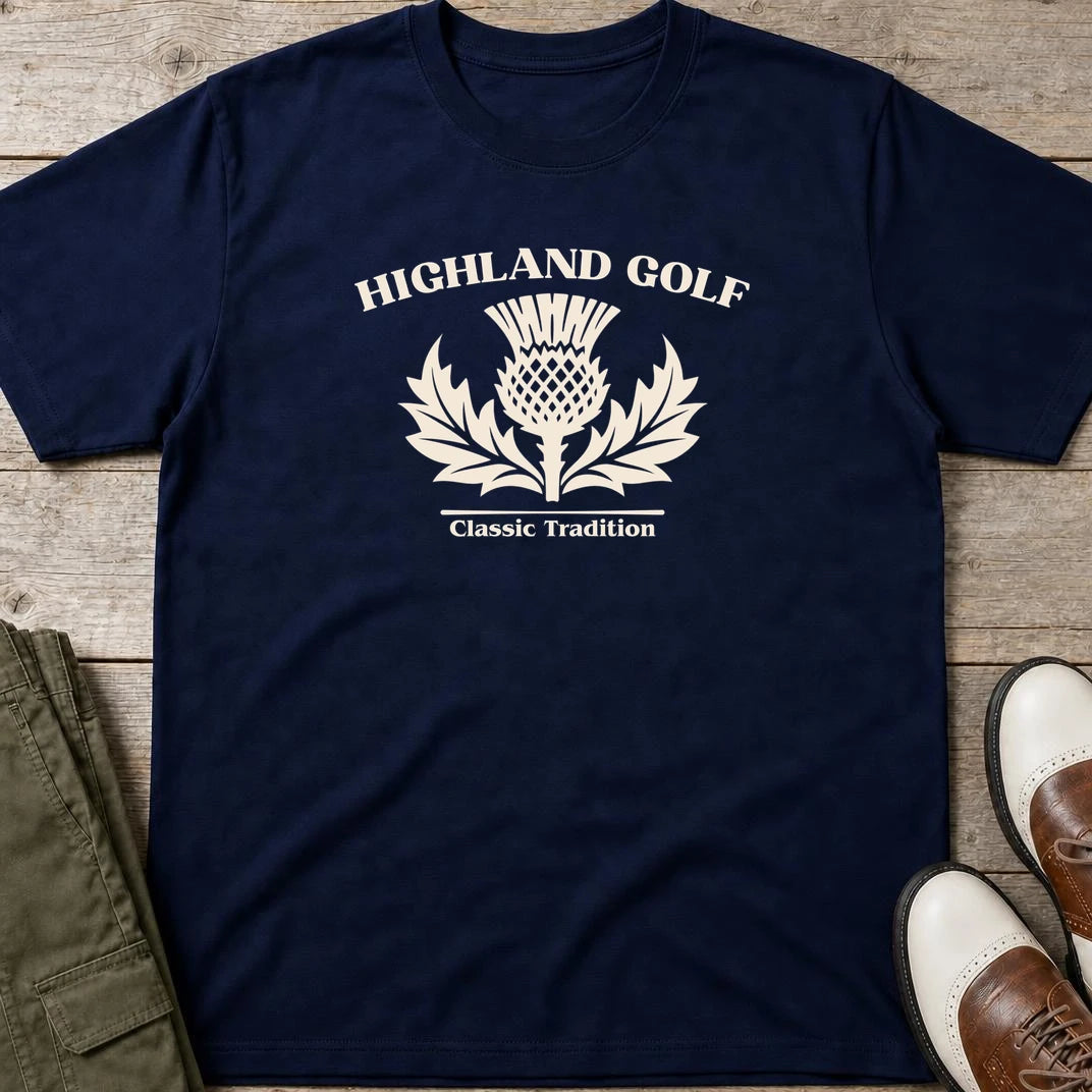 Highland Golf T-Shirt in Navy lying on a plain floor. T-shirt is a unisex cut and 100 per cent cotton.