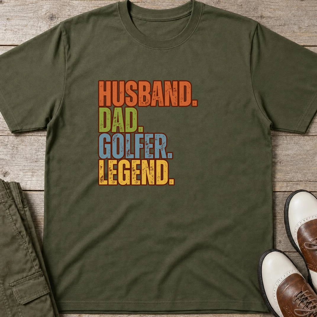 Husband Dad T-Shirt in Military Green lying on a plain floor. T-shirt is a unisex cut and 100 per cent cotton.