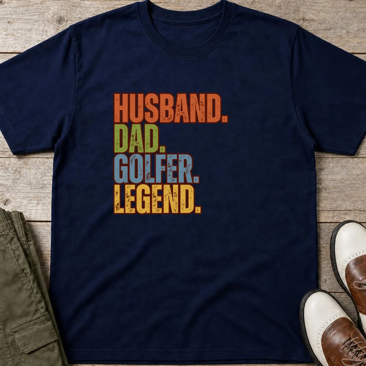Husband Dad T-Shirt in Navy lying on a plain floor. T-shirt is a unisex cut and 100 per cent cotton.