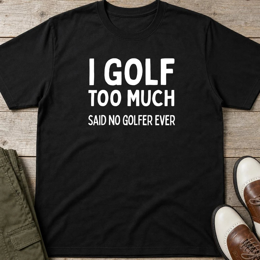 Golf Too Much T-Shirt in Black lying on a plain floor. T-shirt is a unisex cut and 100 per cent cotton.