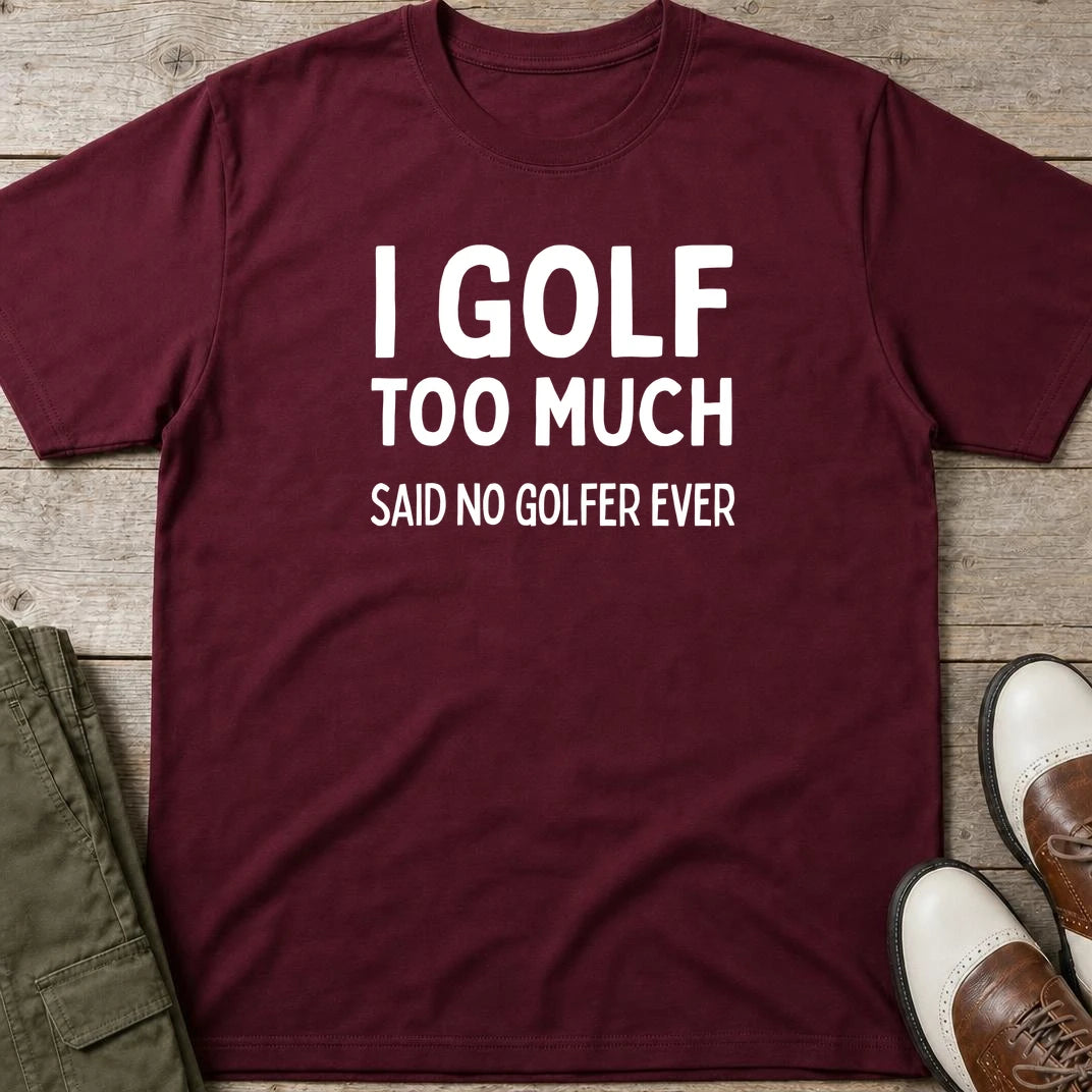 Golf Too Much T-Shirt in Maroon lying on a plain floor. T-shirt is a unisex cut and 100 per cent cotton.