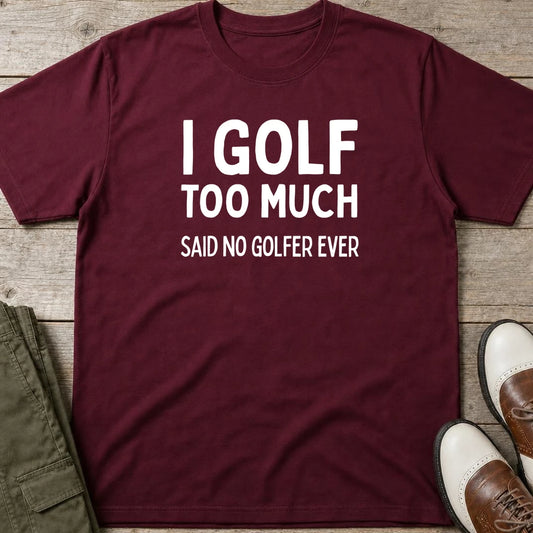 Golf Too Much T-Shirt in Maroon lying on a plain floor. T-shirt is a unisex cut and 100 per cent cotton.
