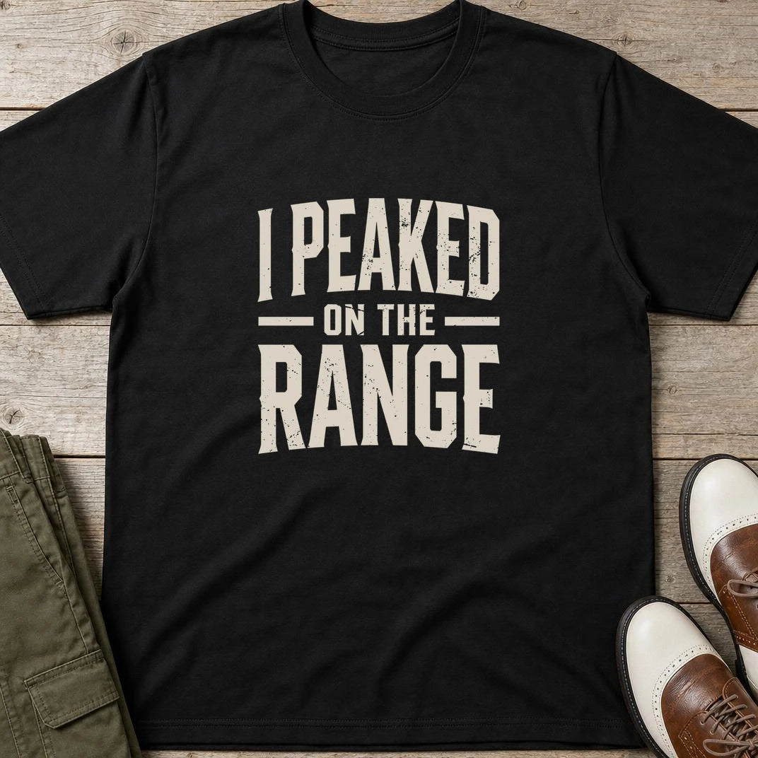 I Peaked T-Shirt in Black lying on a plain floor. T-shirt is a unisex cut and 100 per cent cotton.