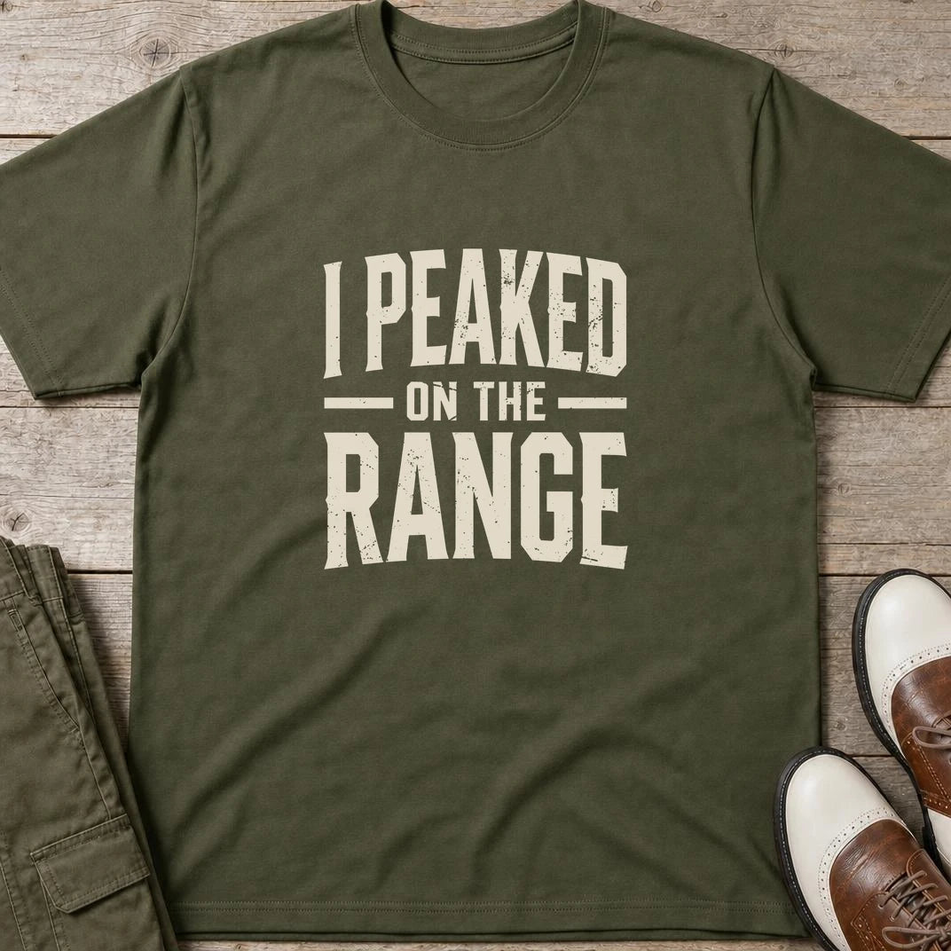 I Peaked T-Shirt in Military Green lying on a plain floor. T-shirt is a unisex cut and 100 per cent cotton.