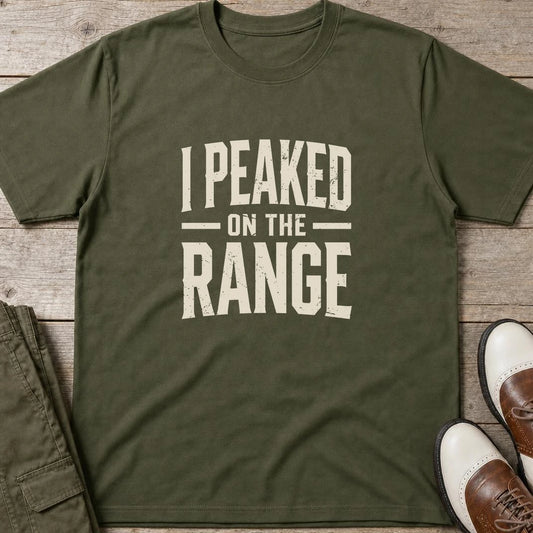 I Peaked T-Shirt in Military Green lying on a plain floor. T-shirt is a unisex cut and 100 per cent cotton.