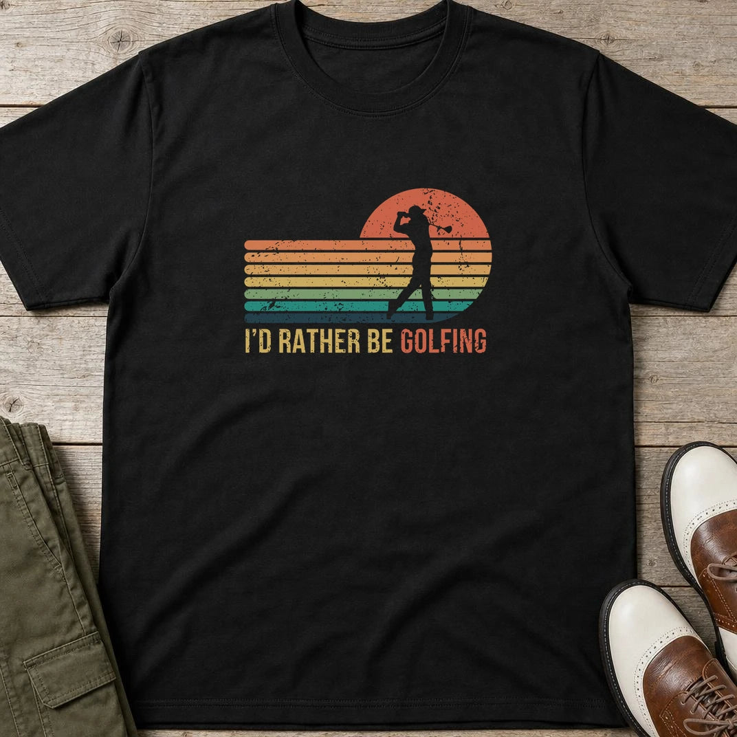 Rather Be Golfing T-Shirt in Black lying on a plain floor. T-shirt is a unisex cut and 100 per cent cotton.