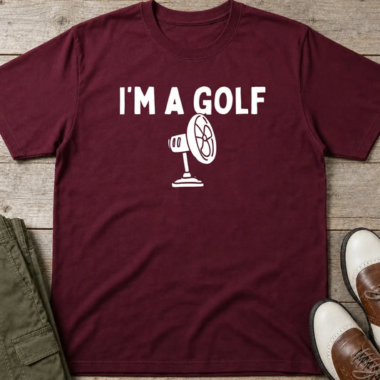 I'm A Golf Fan T-Shirt in Maroon lying on a plain floor. T-shirt is a unisex cut and 100 per cent cotton.