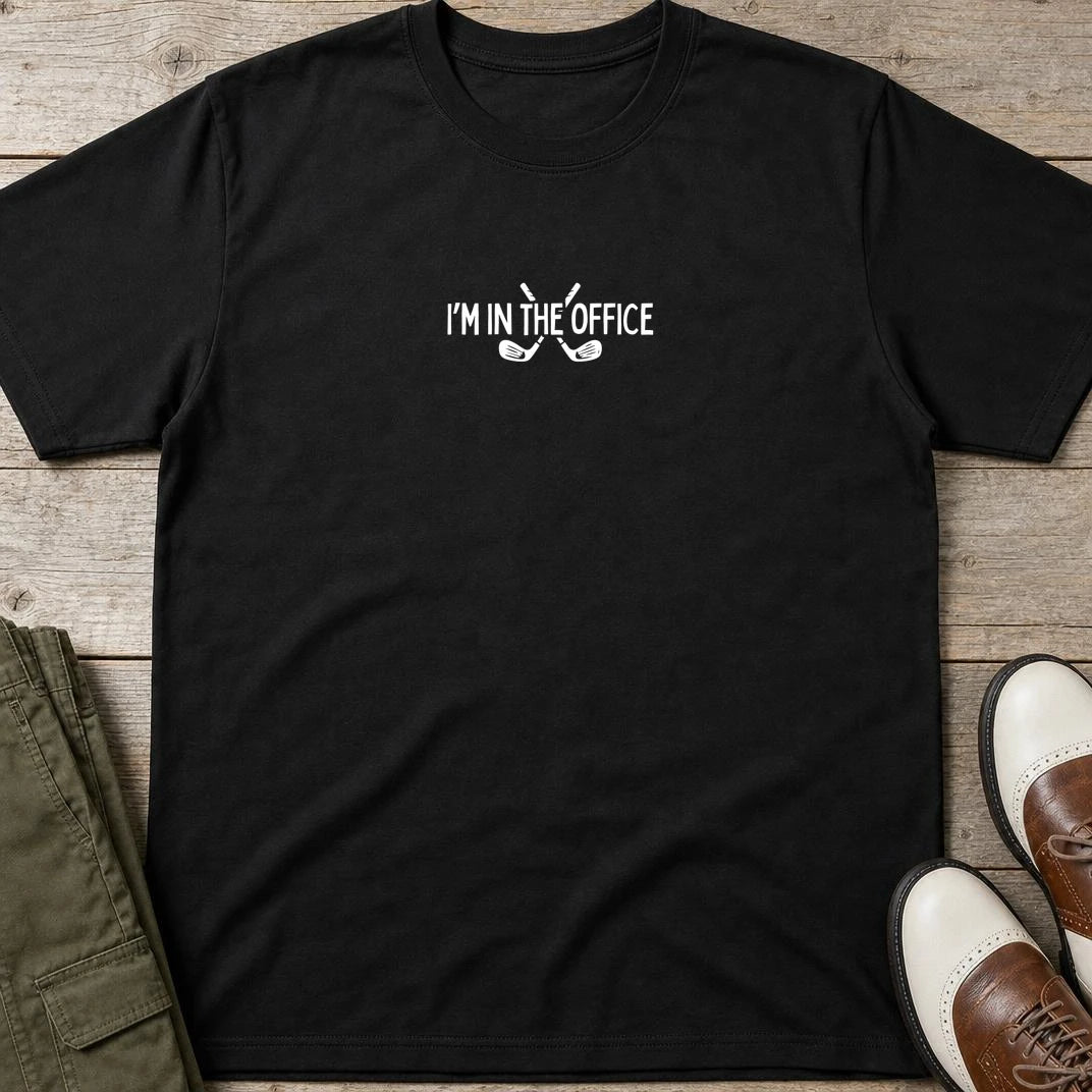 In The Office T-Shirt in Black lying on a plain floor. T-shirt is a unisex cut and 100 per cent cotton.