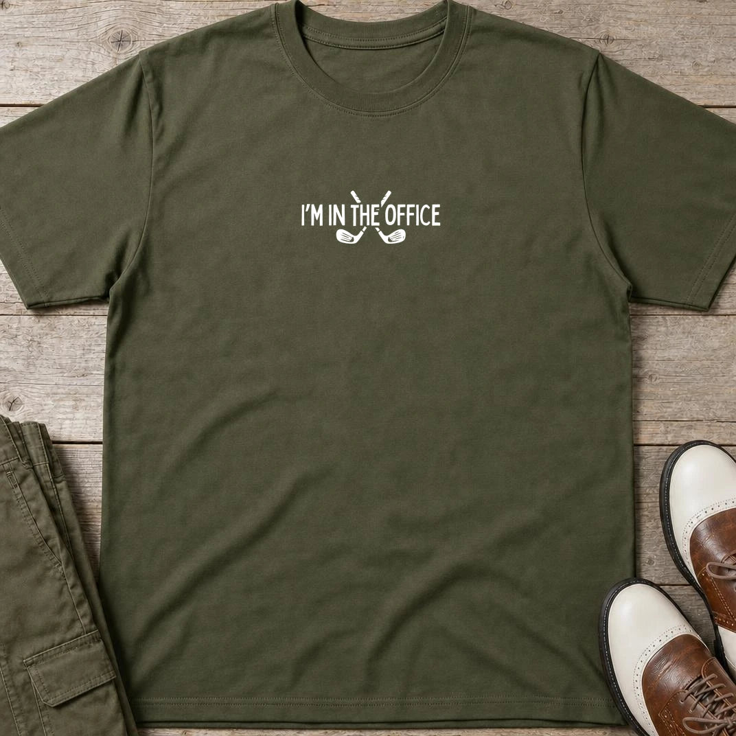 In The Office T-Shirt in Military Green lying on a plain floor. T-shirt is a unisex cut and 100 per cent cotton.