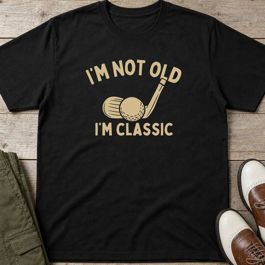 I'm Classic T-Shirt in Black lying on a plain floor. T-shirt is a unisex cut and 100 per cent cotton.