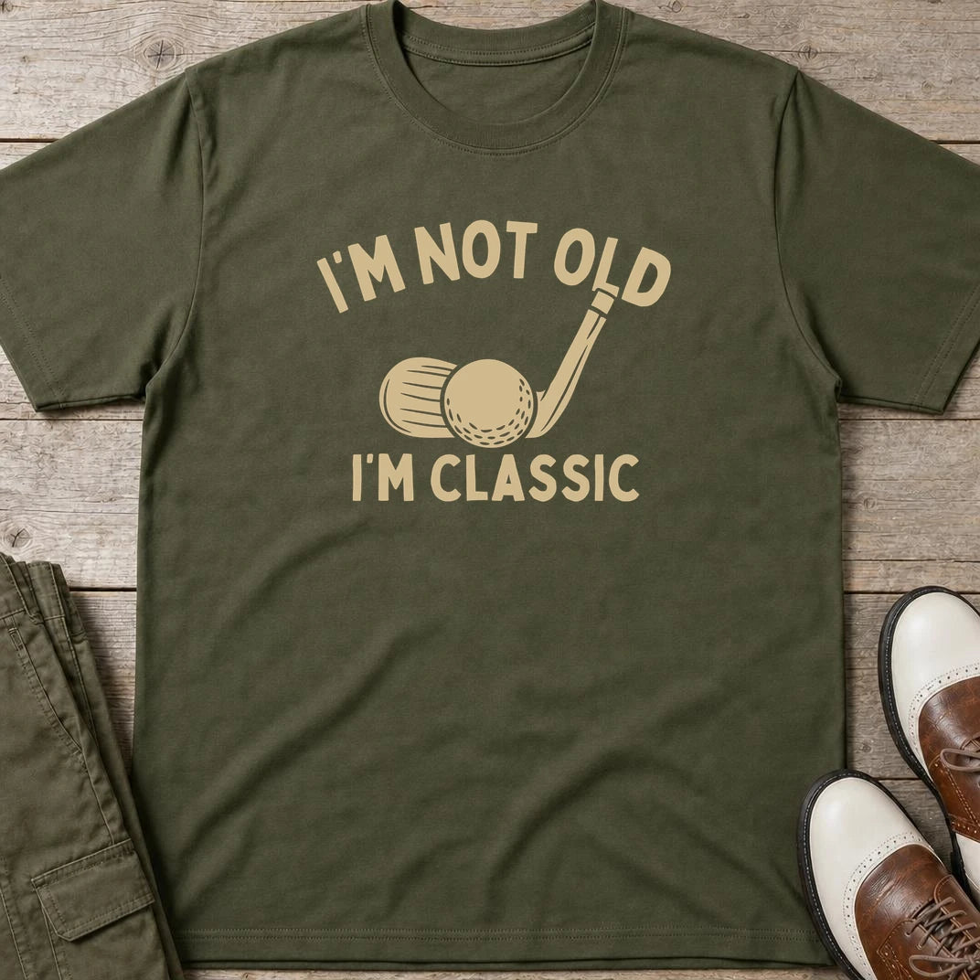 I'm Classic T-Shirt in Military Green lying on a plain floor. T-shirt is a unisex cut and 100 per cent cotton.