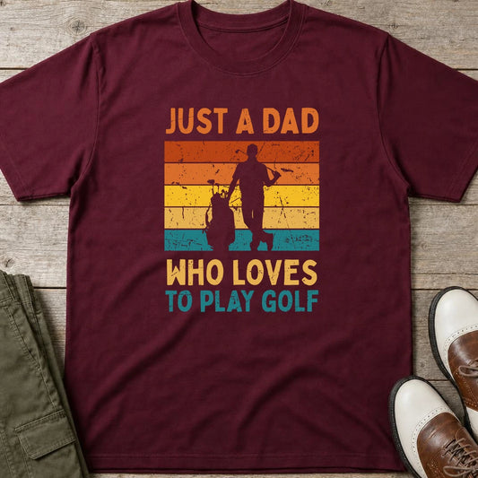 Just A Dad T-Shirt in Maroon lying on a plain floor. T-shirt is a unisex cut and 100 per cent cotton.