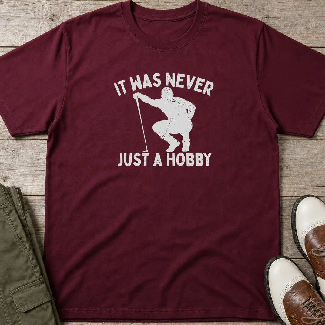 Just A Hobby T-Shirt in Maroon lying on a plain floor. T-shirt is a unisex cut and 100 per cent cotton.