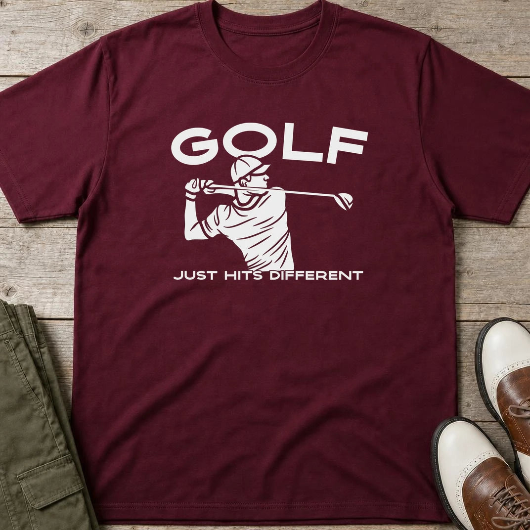 Hits Different T-Shirt in Maroon lying on a plain floor. T-shirt is a unisex cut and 100 per cent cotton.