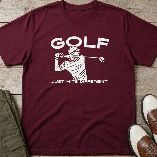 Hits Different T-Shirt in Maroon lying on a plain floor. T-shirt is a unisex cut and 100 per cent cotton.