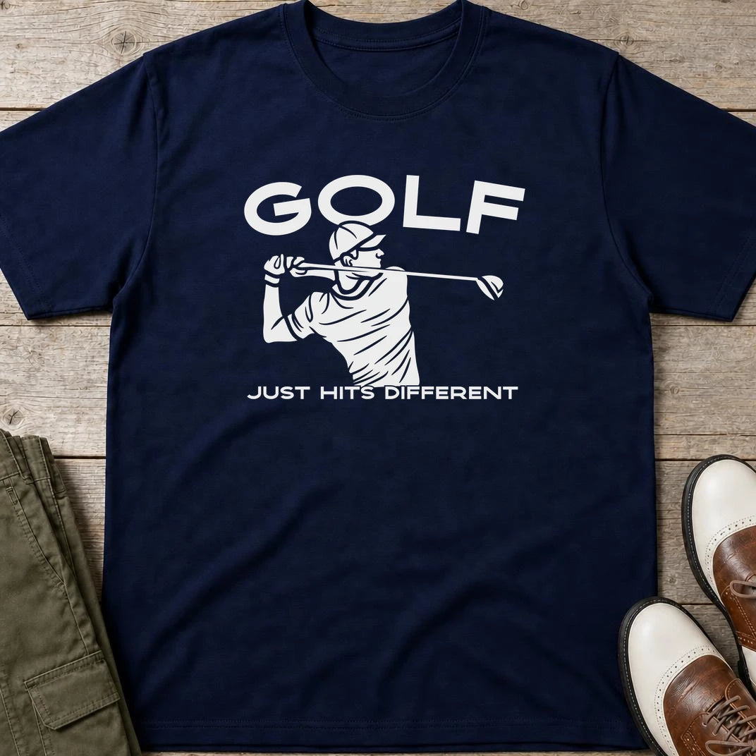 Hits Different T-Shirt in Navy lying on a plain floor. T-shirt is a unisex cut and 100 per cent cotton.