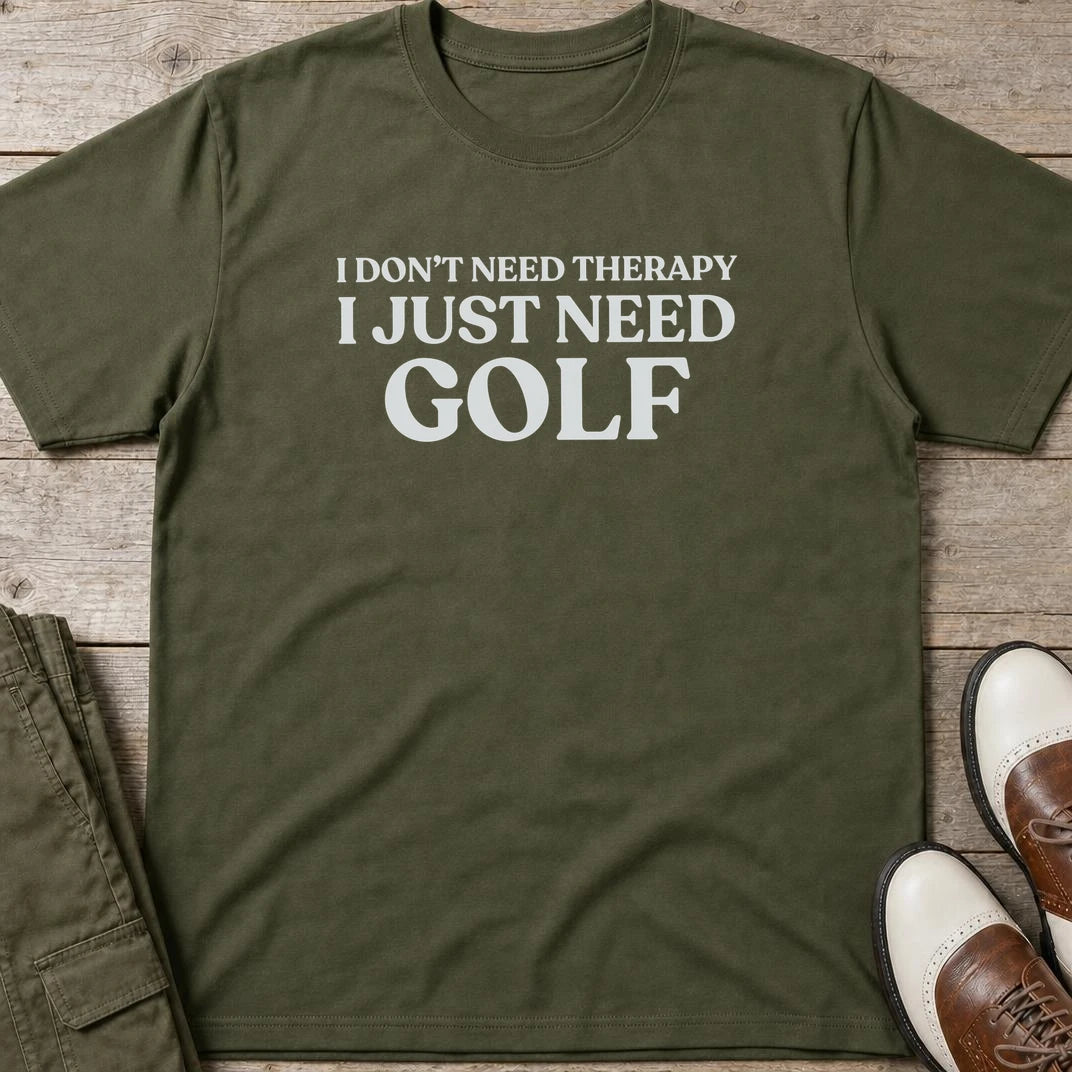 Just Need Golf T-Shirt in Military Green lying on a plain floor. T-shirt is a unisex cut and 100 per cent cotton.