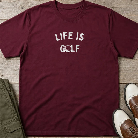 Life Is Golf T-Shirt in Maroon lying on a plain floor. T-shirt is a unisex cut and 100 per cent cotton.