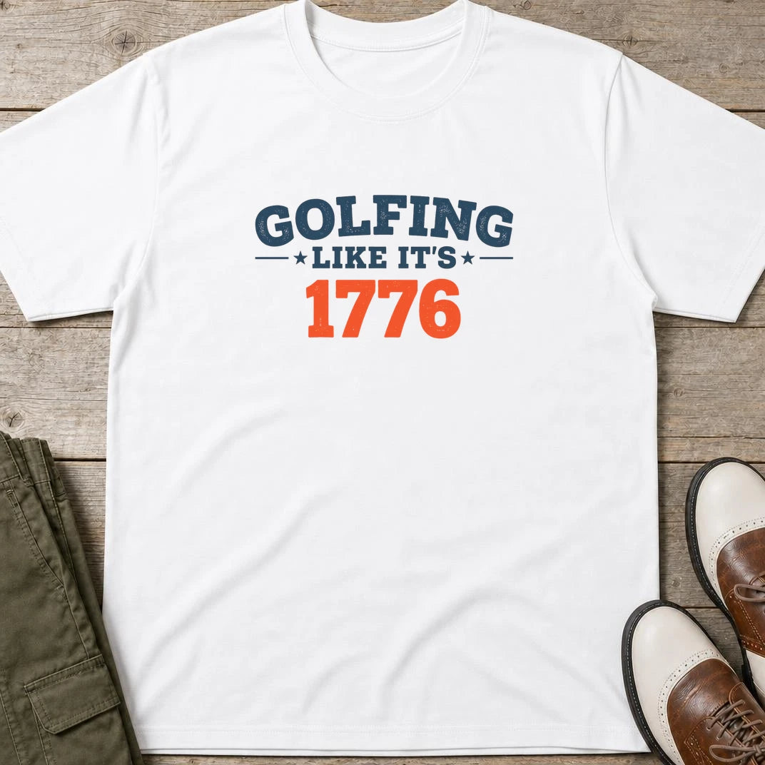 Golfing 1776 T-Shirt in White lying on a plain floor. T-shirt is a unisex cut and 100 per cent cotton.