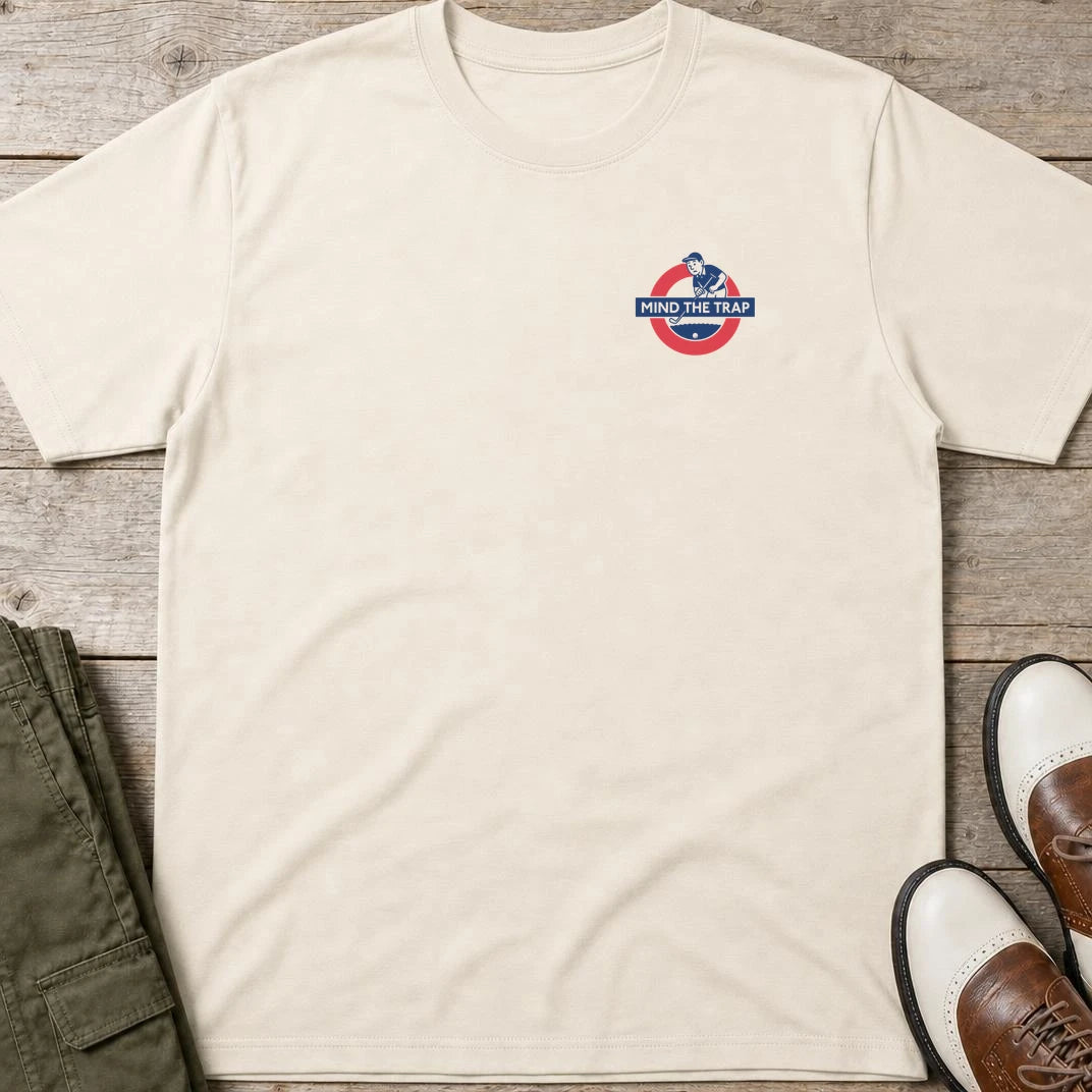 Mind Trap Pocket T-Shirt in Natural lying on a plain floor. T-shirt is a unisex cut and 100 per cent cotton.
