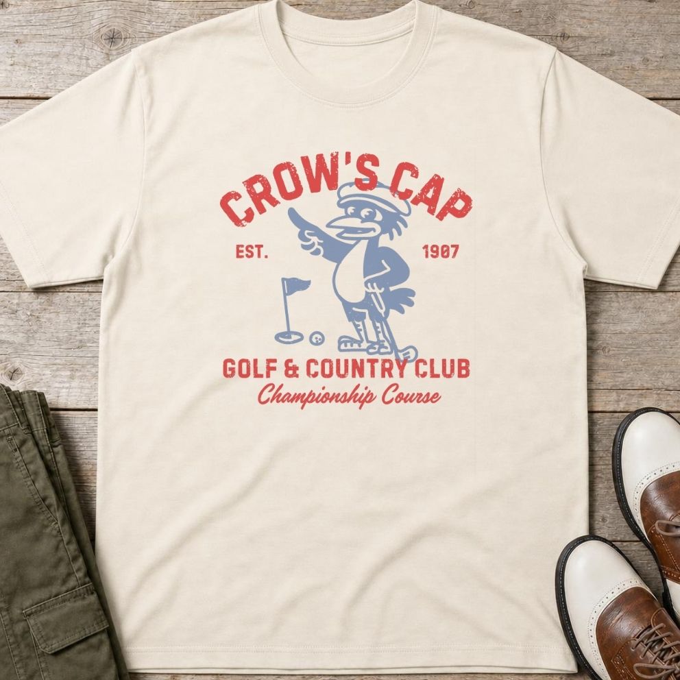 Crow's Cap T-Shirt in lying on a plain floor. T-shirt is a unisex cut and 100 per cent cotton.
