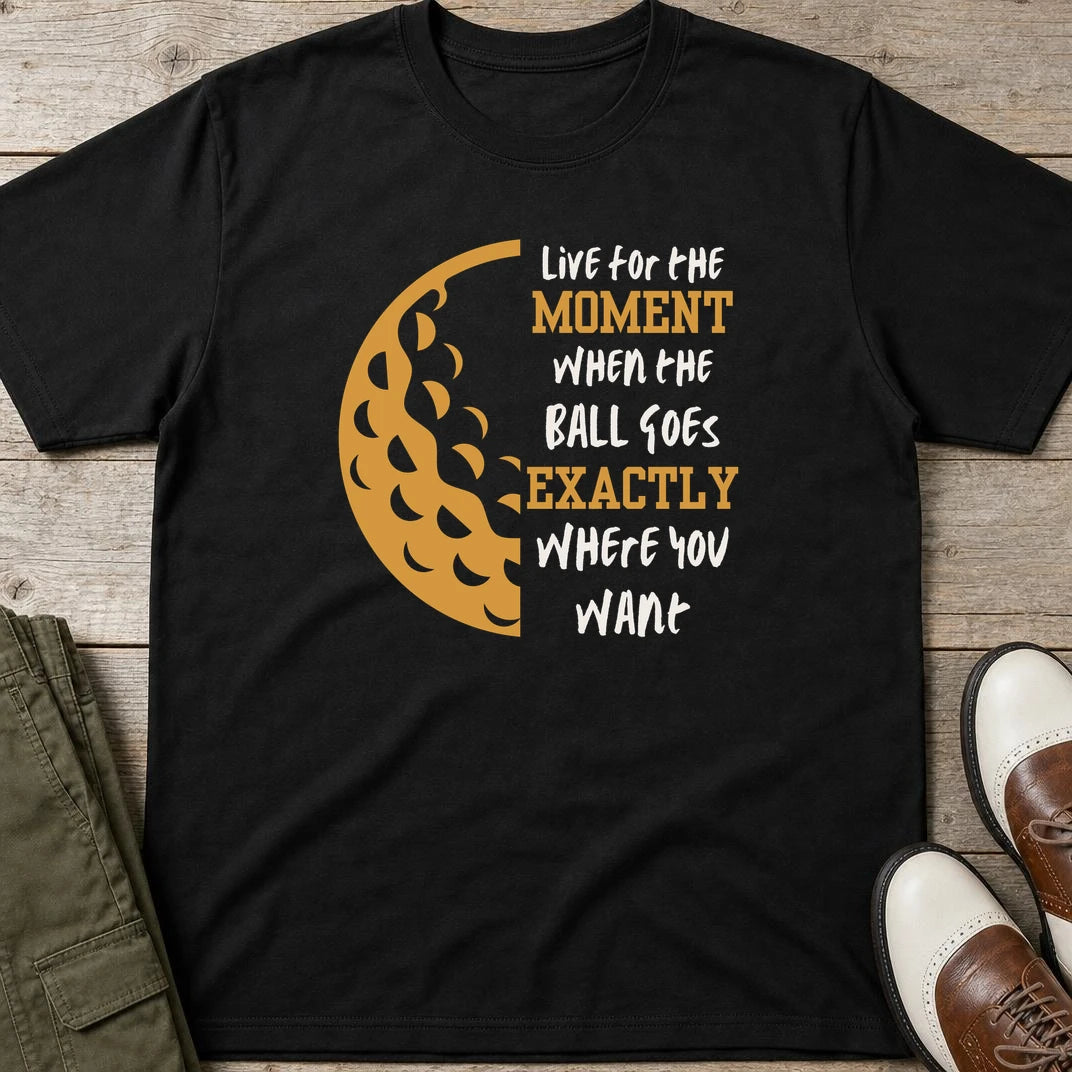 The Moment T-Shirt in Black lying on a plain floor. T-shirt is a unisex cut and 100 per cent cotton.
