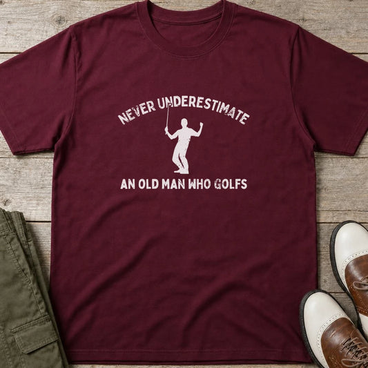 Old Man T-Shirt in Maroon lying on a plain floor. T-shirt is a unisex cut and 100 per cent cotton.