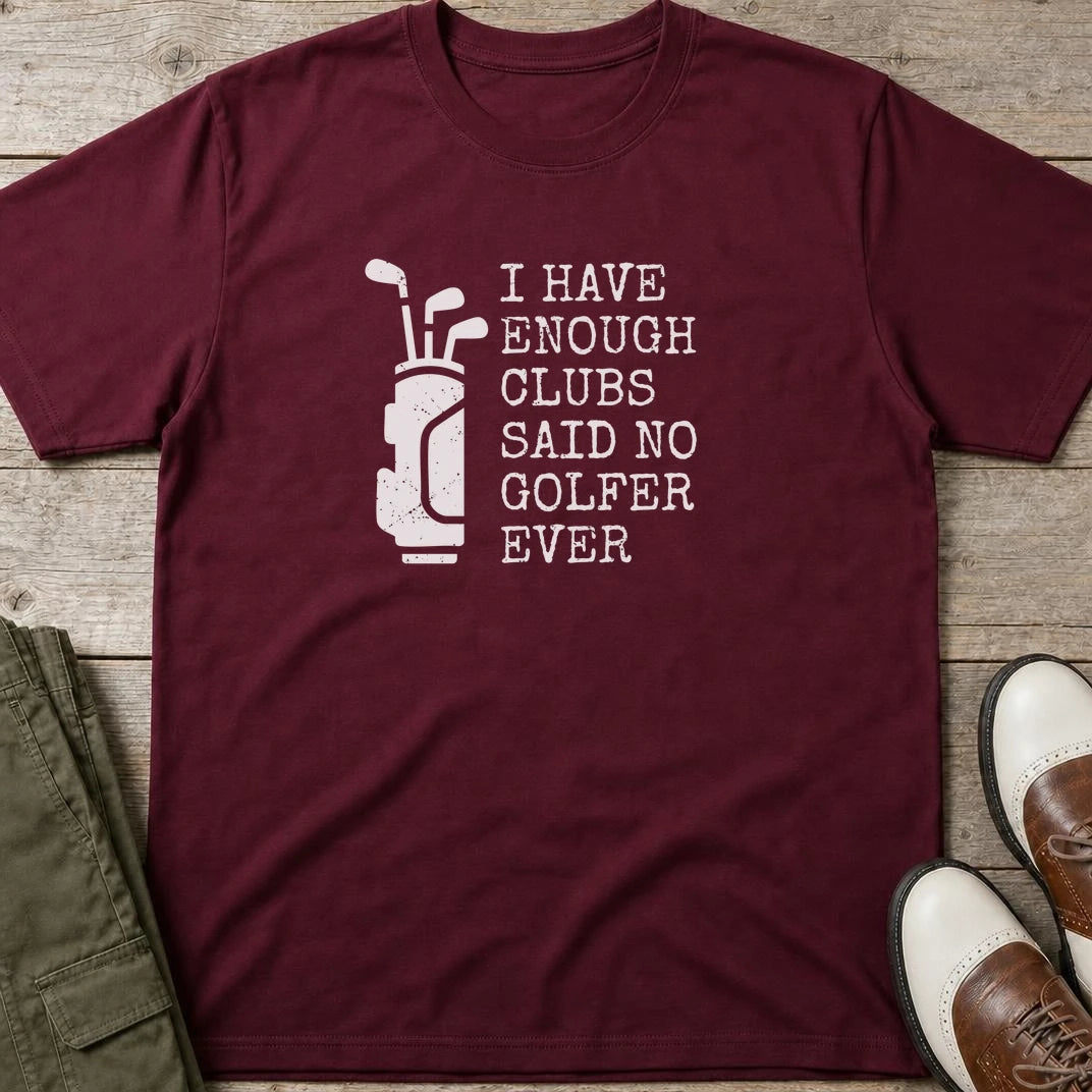 Enough Clubs T-Shirt in Maroon lying on a plain floor. T-shirt is a unisex cut and 100 per cent cotton.