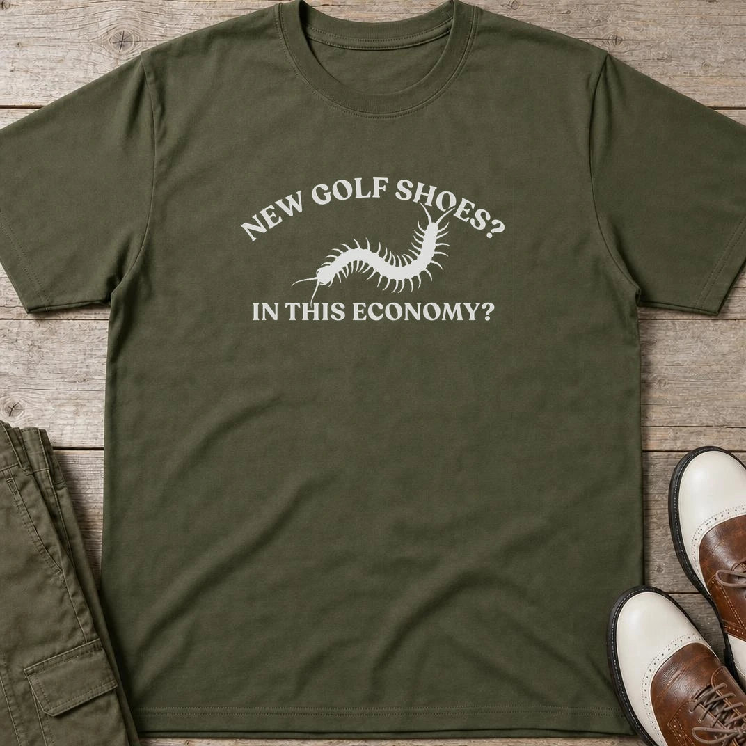 Golf Shoes T-Shirt in Military Green lying on a plain floor. T-shirt is a unisex cut and 100 per cent cotton.