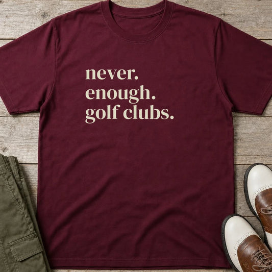 Never Enough T-Shirt in Maroon lying on a plain floor. T-shirt is a unisex cut and 100 per cent cotton.