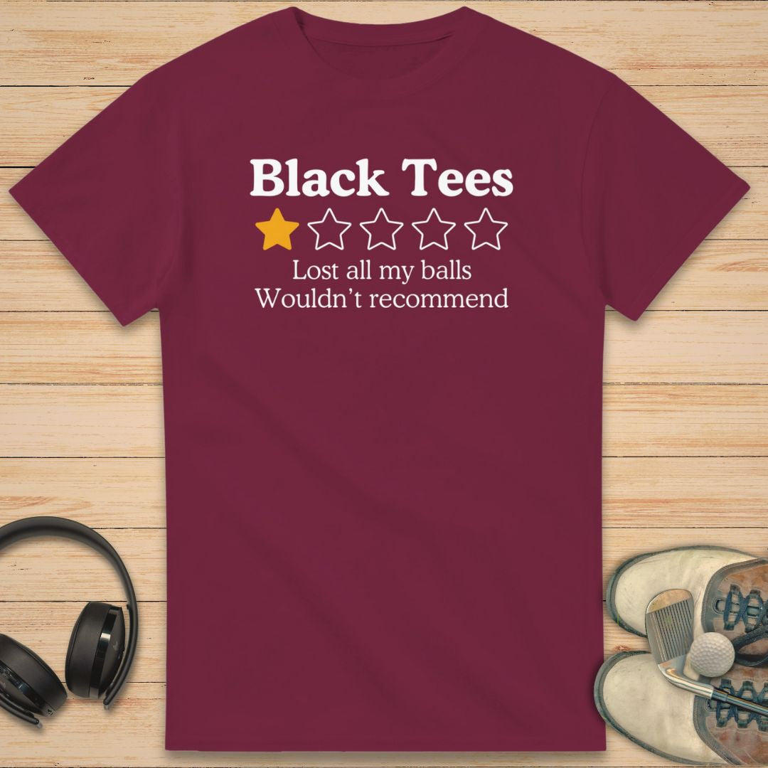 Black Tees T-Shirt in Maroon on a light wooden floor lying next to headphones and golf shoes.