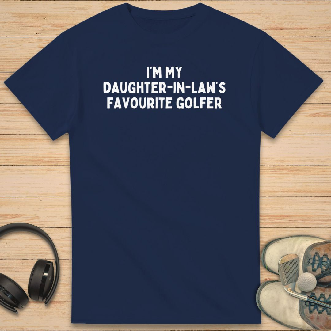 Daughter-In-Law T-Shirt in Navy on a light wooden floor lying next to headphones and golf shoes.